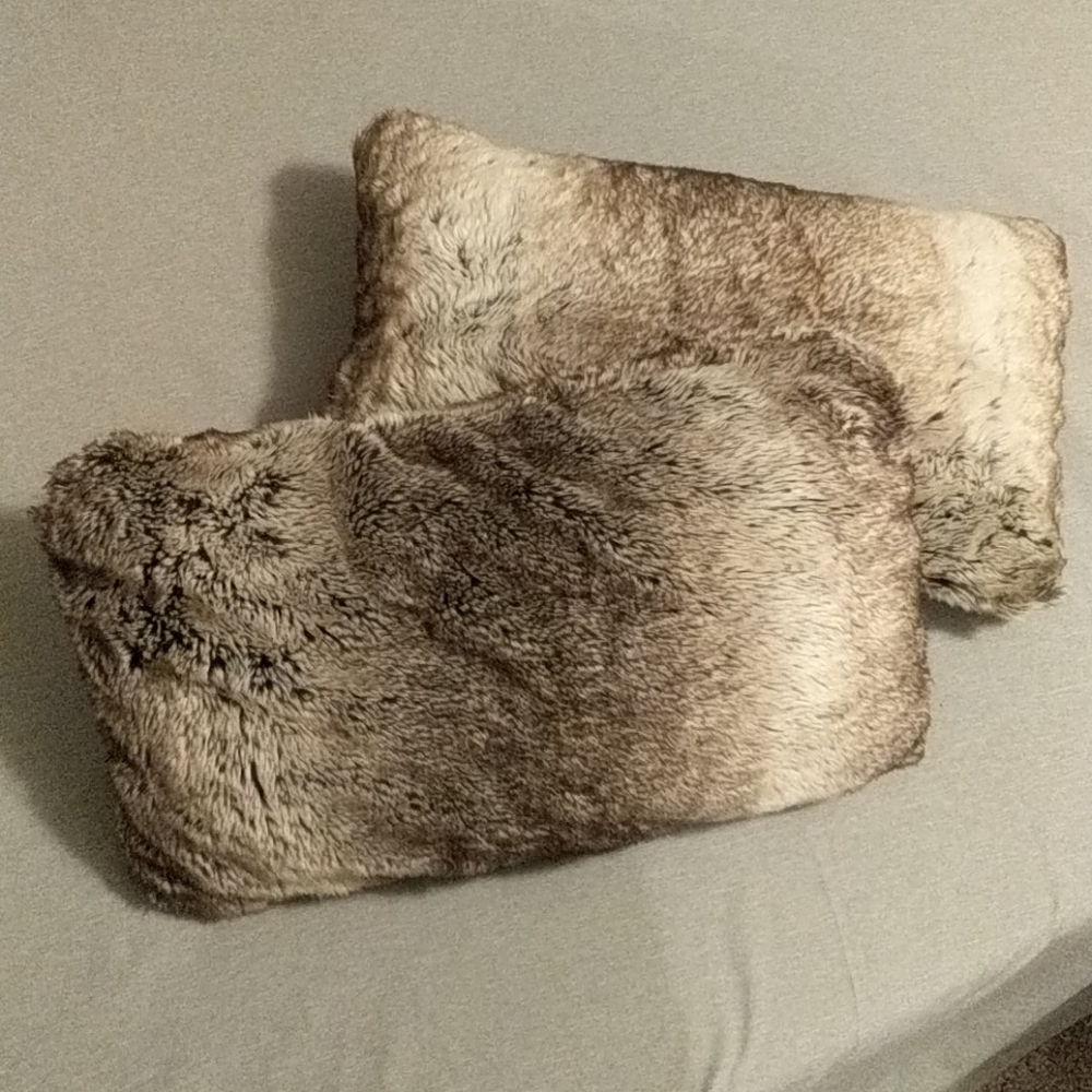 Two matching faux fur pillows